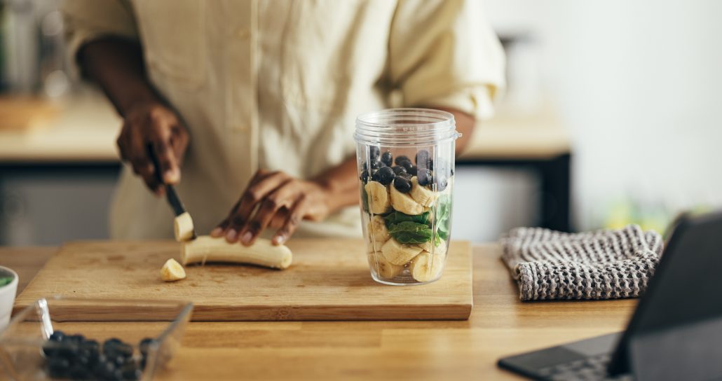 Woman prepping food for a smoothie.