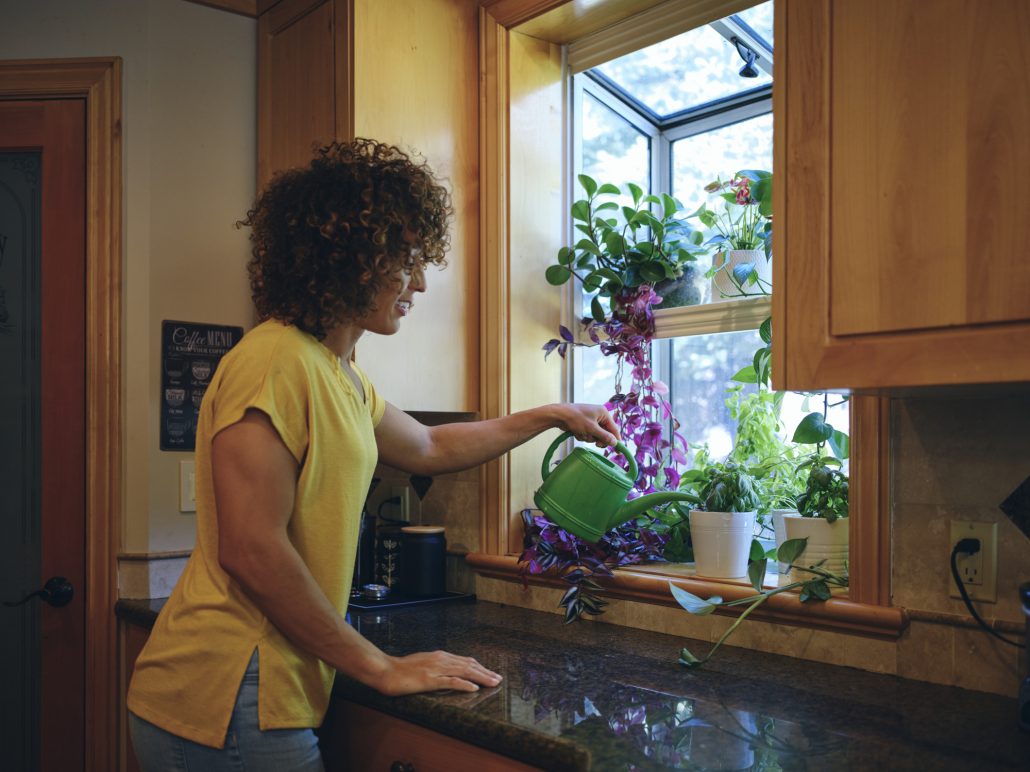 Woman caring for her herb garden.