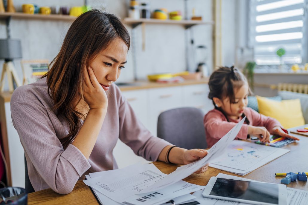 Woman going over finances with child.