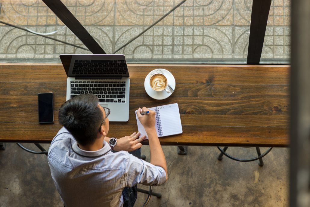 Person taking notes on the current state of the employee benefits market.