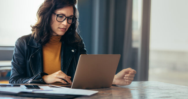 Woman looking over compliance materials.
