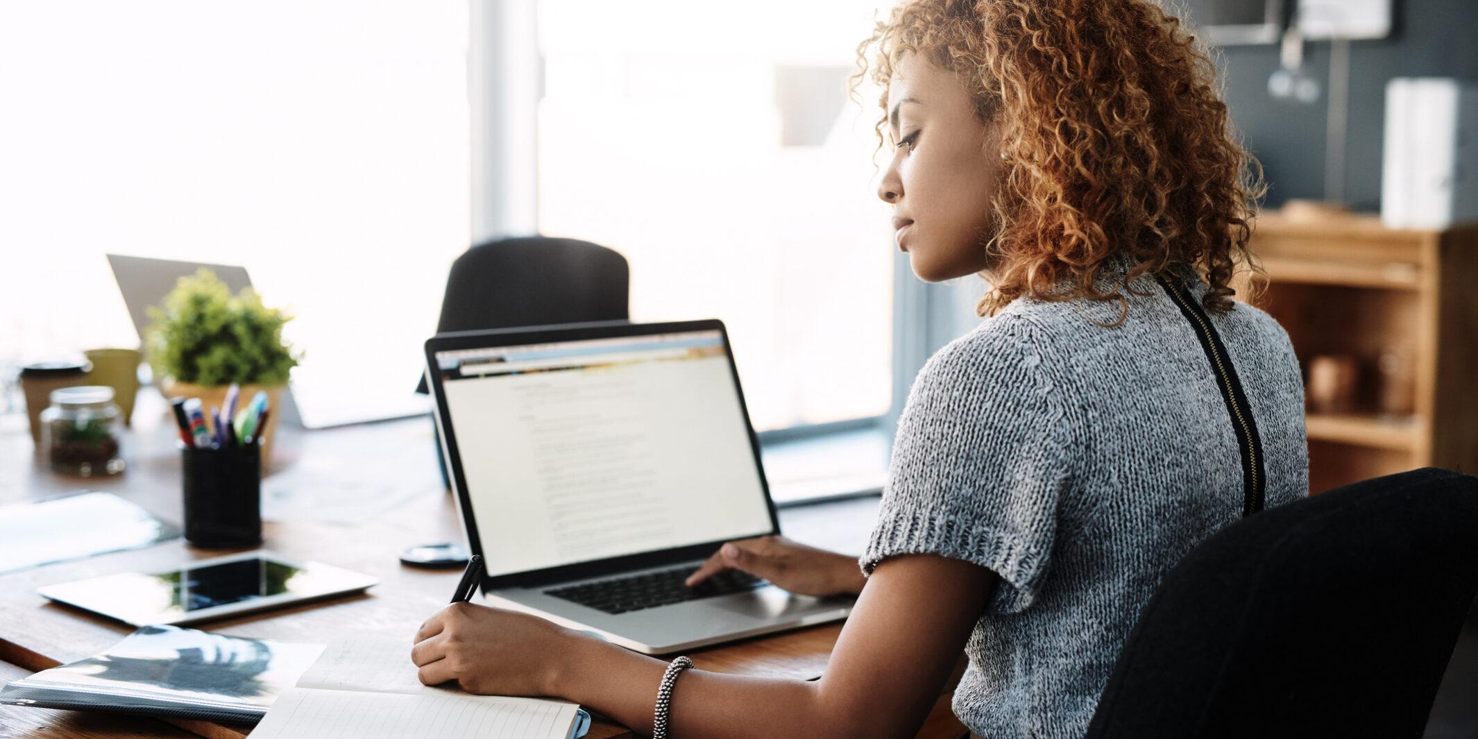Shot of a young businesswoman working on a laptop in an office
