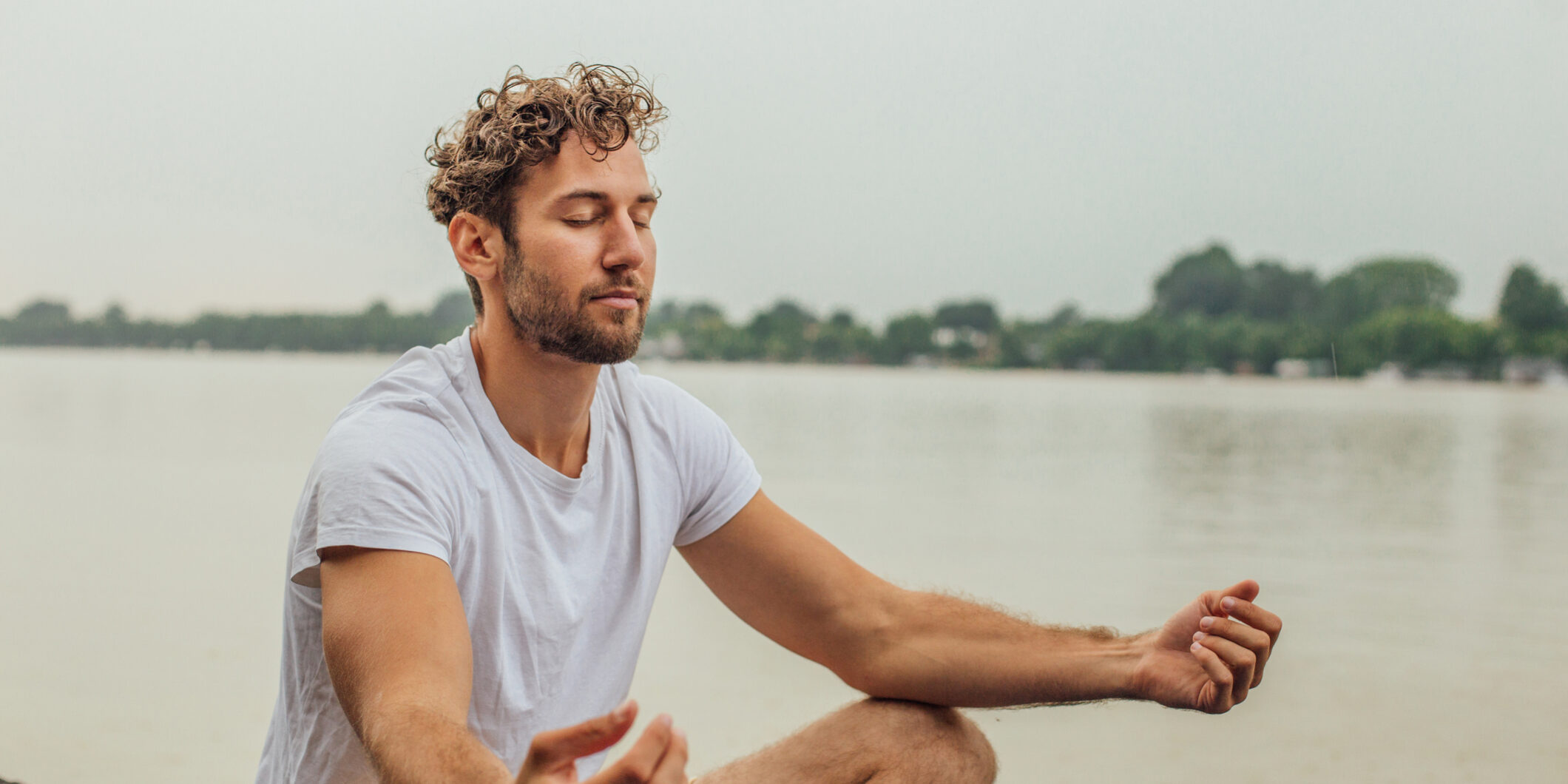 Young man doing yoga outdoors