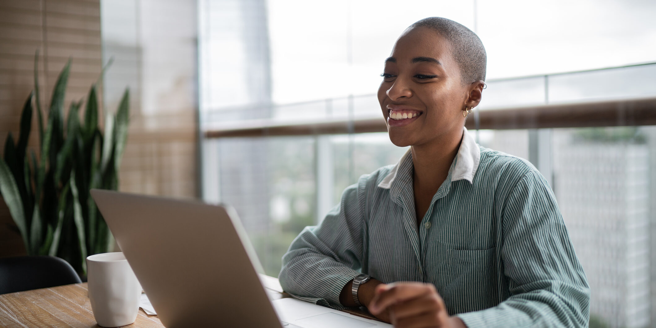 Young woman working and doing a virtual business meeting on laptop at home