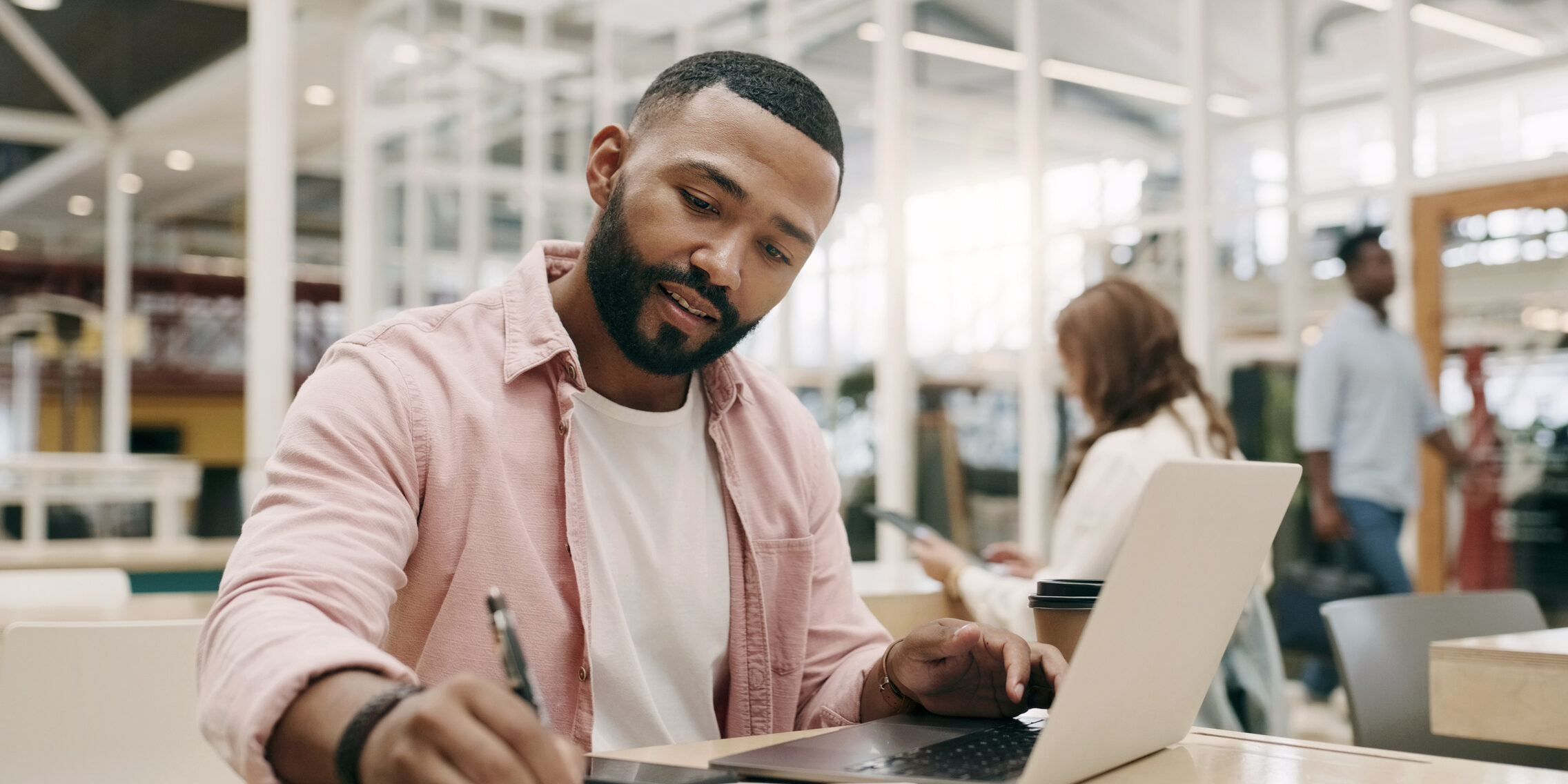 Writing, creative and man with laptop in office for business, project or research in startup. Computer, notes and African professional copywriter working on book for planning, web schedule and email.