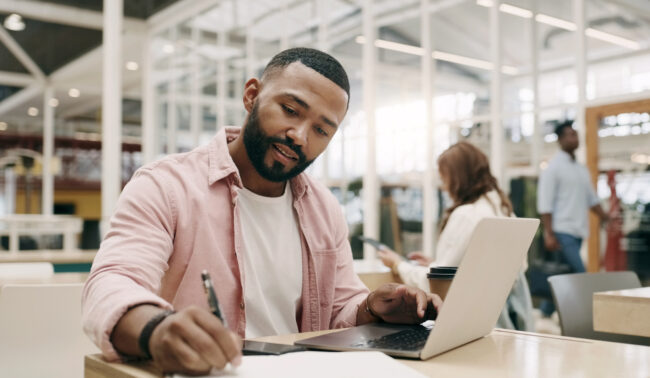 Writing, creative and man with laptop in office for business, project or research in startup. Computer, notes and African professional copywriter working on book for planning, web schedule and email.