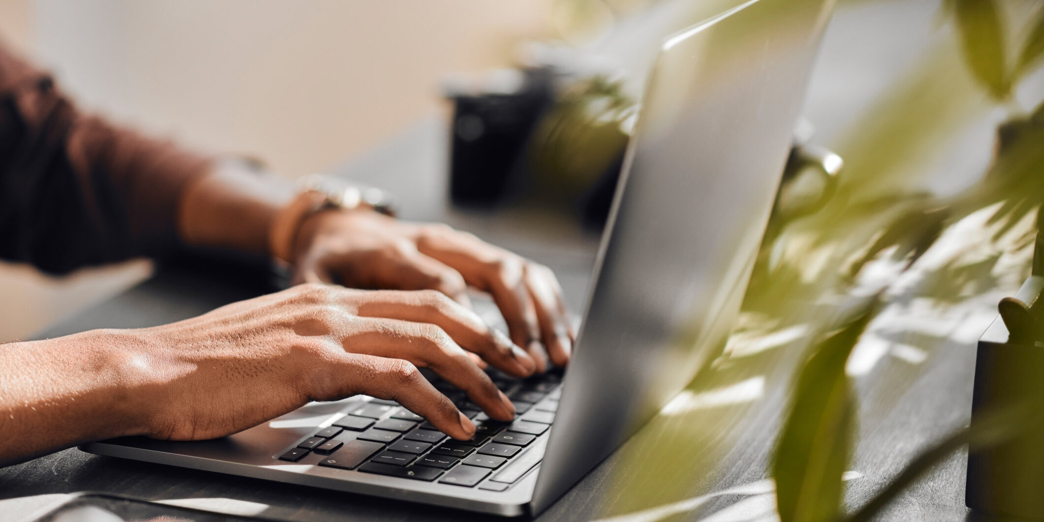 Black man typing on laptop, contact us online and computer technology for ecommerce website. Writing email on keyboard, person searching internet and employee working with 5g connection at desk