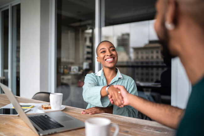 Interview handshake between two people.