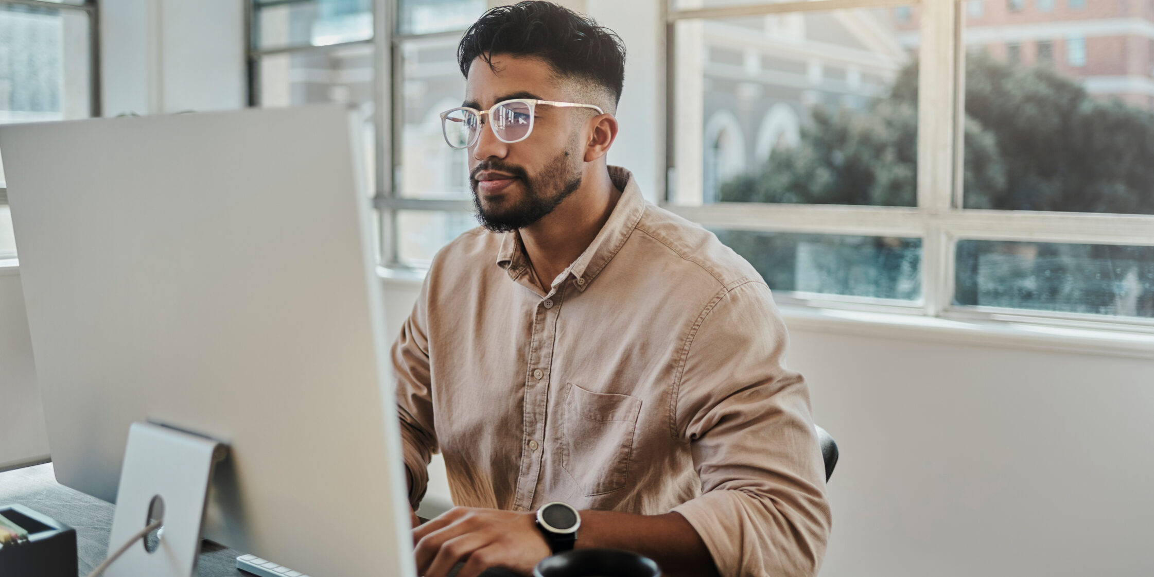 Information technology businessman working on computer in office for digital app, software development or website ux ui design. Young graphic designer with coding project or online company management