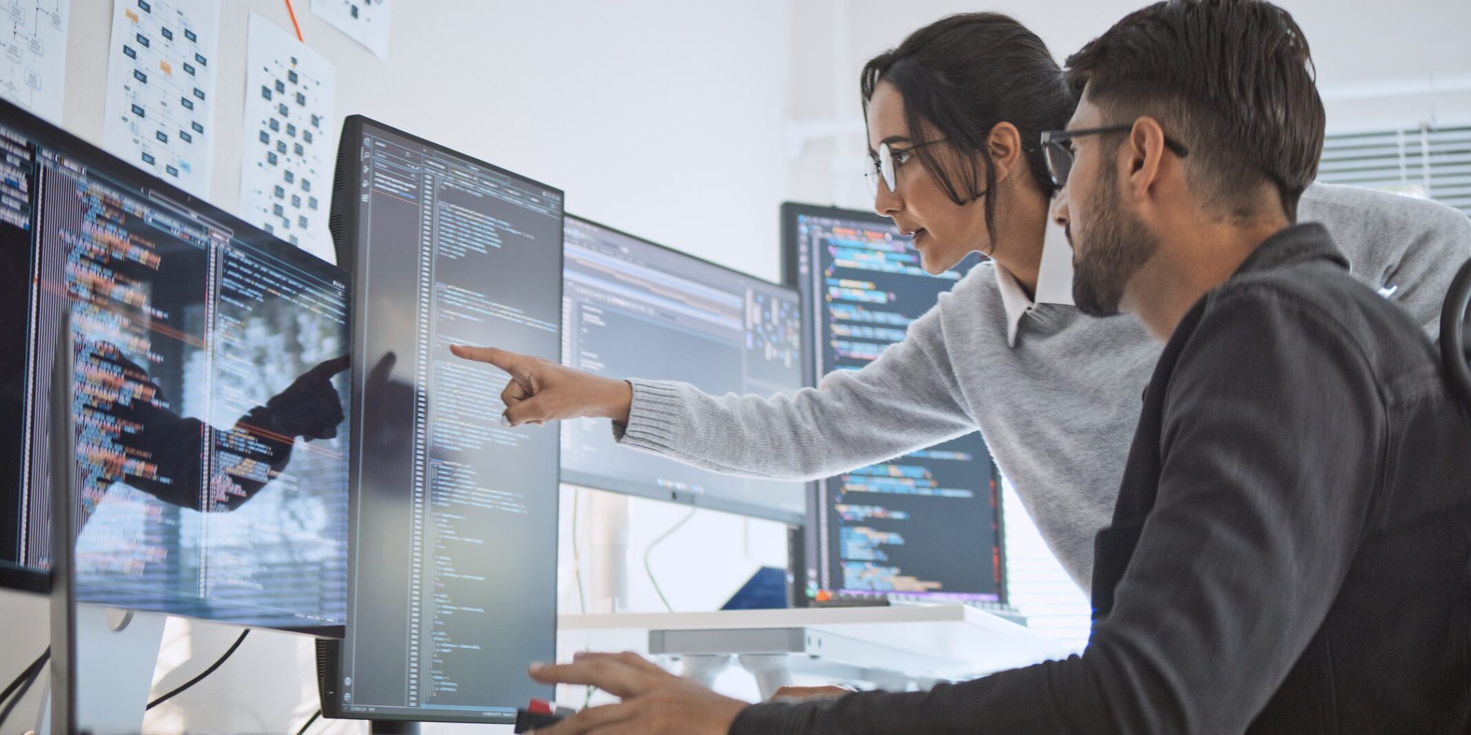 Hispanic Latin American couple, software engineer developer use computer, work on program coding together at home office. Programming language development technology, freelance job concept