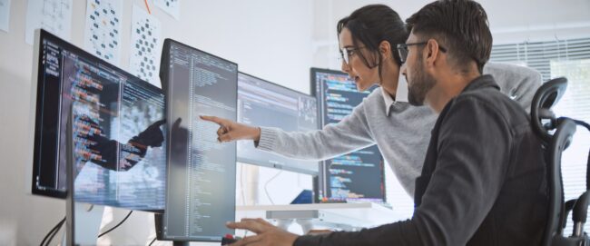Hispanic Latin American couple, software engineer developer use computer, work on program coding together at home office. Programming language development technology, freelance job concept